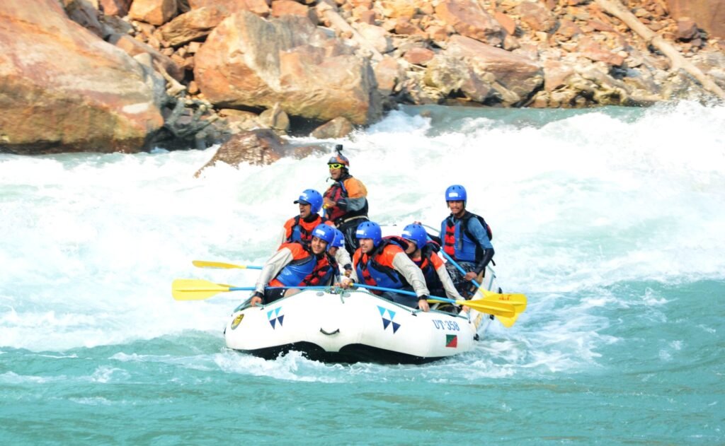 Raft punching through a Grade III rapid on the Ganga in Rishikesh