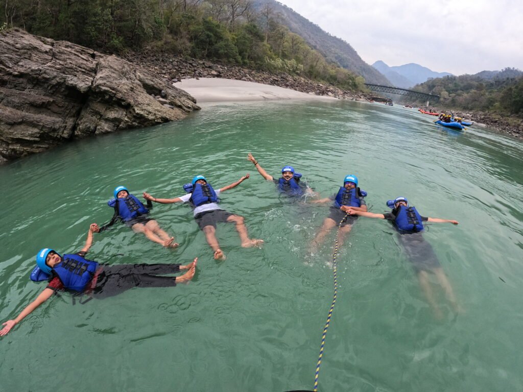 Rafters floating in life jackets on a calm stretch of the Ganga