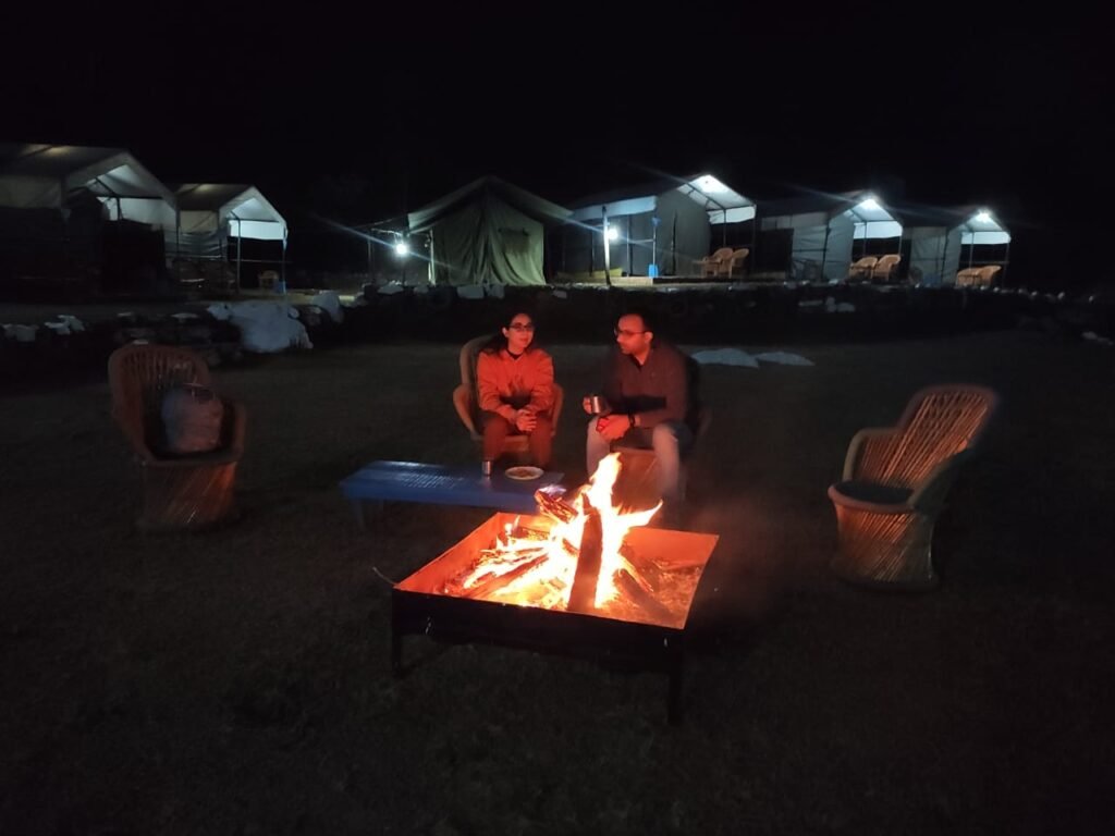 Guests around a bonfire on a cool November night at our camp near Rishikesh
