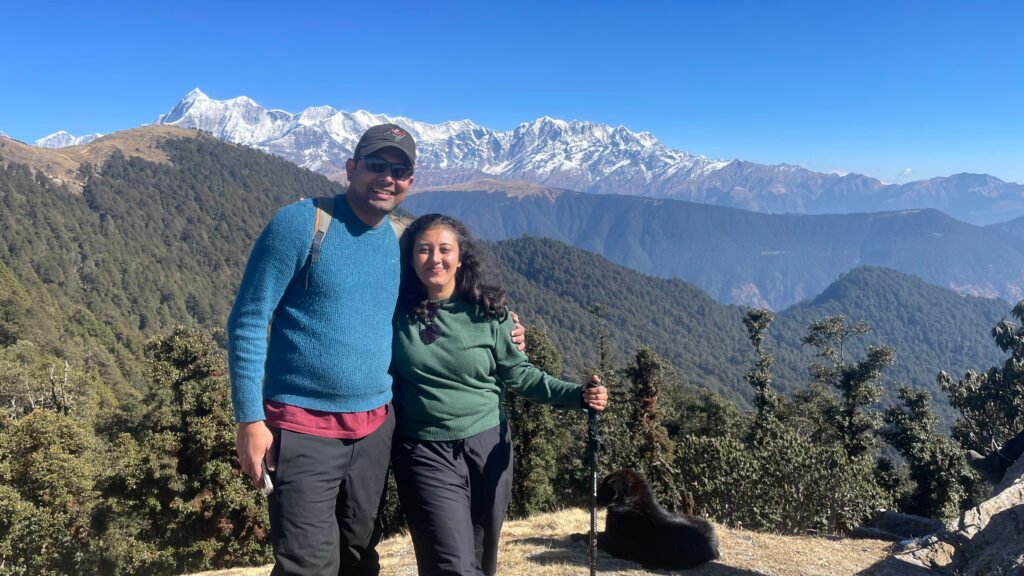 Couple below snow-capped peaks on the Brahmatal trek