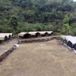 Wide view of the campsite and tents in the forest valley near Rishikesh