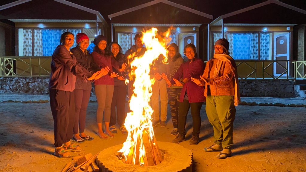 Bonfire with trekkers on a winter trek in Uttarakhand